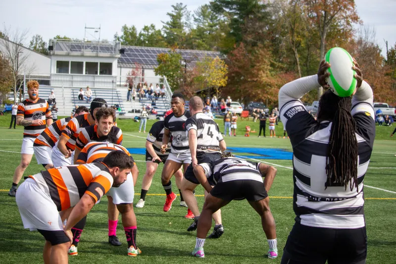 A Lions hooker lines up a lineout throw against a side in orange hoops