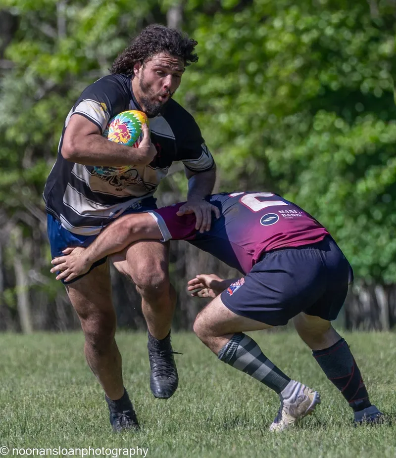 A Lions player steps off his left foot past a defender