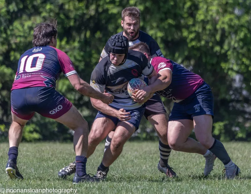 A Lions forward drives into contact with the ball tucked under one arm