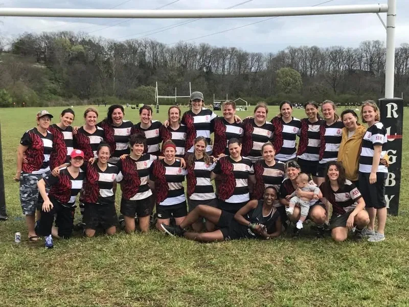 The H.E.A.T. squad gathered in front of the posts in hooped jerseys, one player holding a baby
